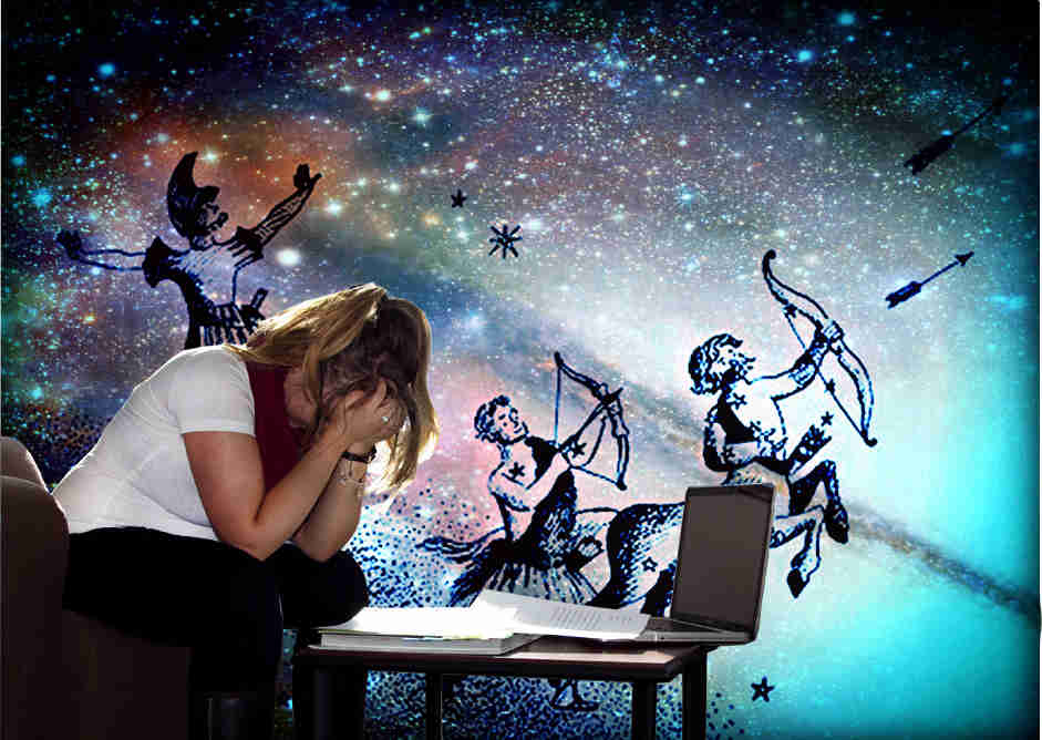 A girl looks at her horoscope and cries while astrological figures are shown in the background