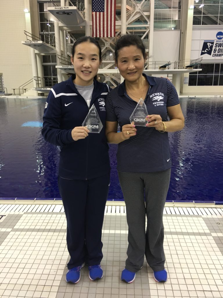 Diving coach Jian Li You poses with diver Sharae Zheng after a successful swiming and diving championship.