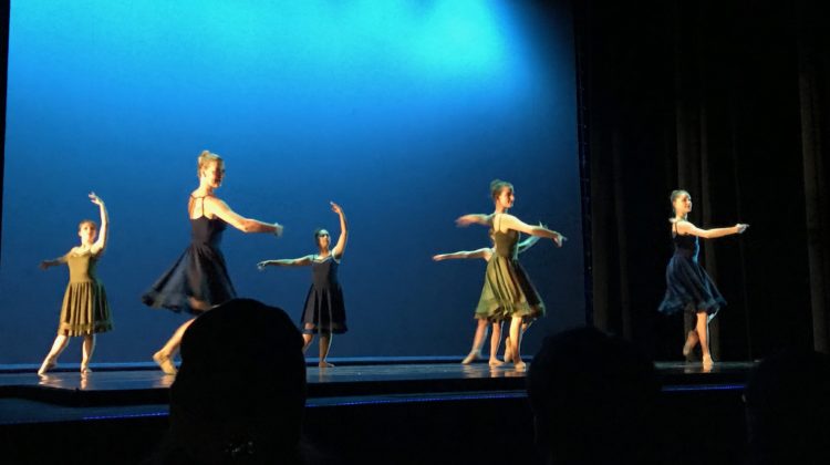 girls-in-colorful-short-flowy-dresses-twirl-onstage-during-Fall-Dance-Festival