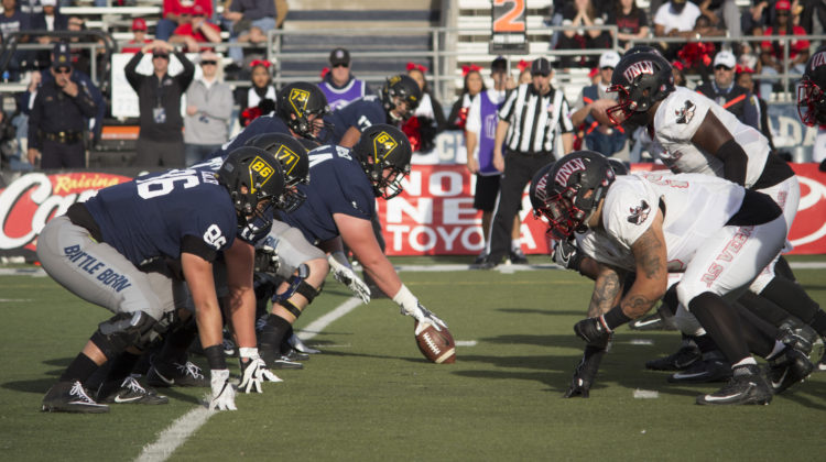 The Nevada offensive line on the left faces off against the UNLV defensive line