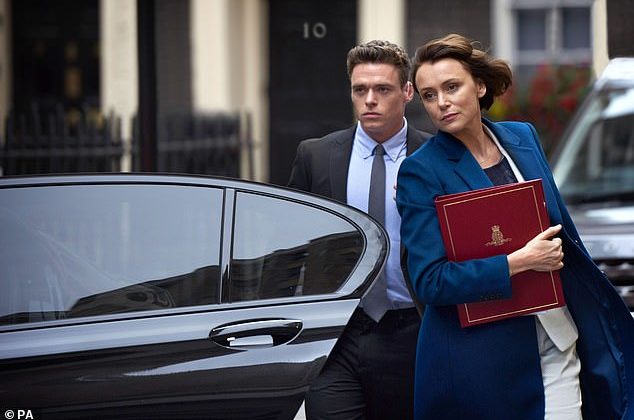 richard-madden-and-keeley-hawes-getting-out-of-a-black-car-as-their-characters-on-bodyguard