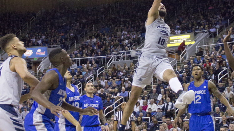 Caleb Martin lays the ball up while four Air Force players look up at him.