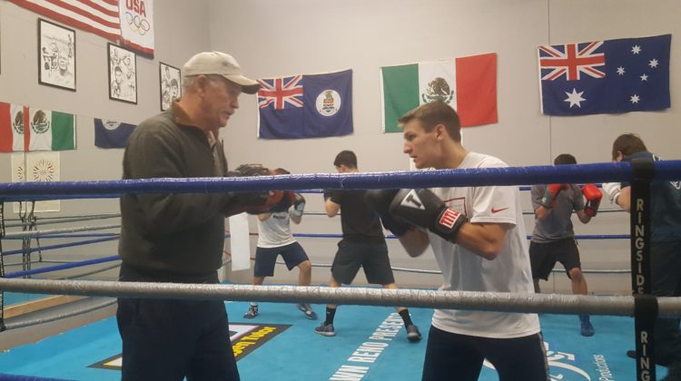 Davis Ault spars with a coach in the boxing ring