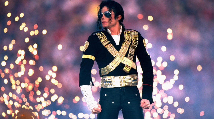 Michael Jackson stands during his 1993 Superbowl Halftime performance as sparks go off behind him.