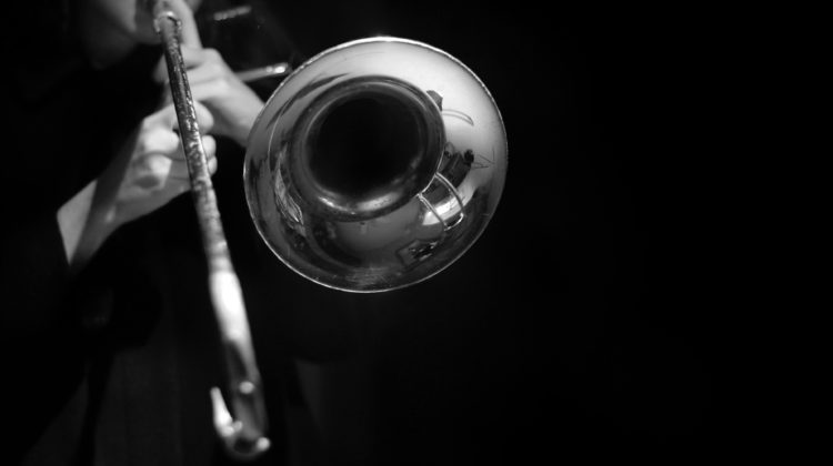 black-and-white-photo-of-man-playing-trombone
