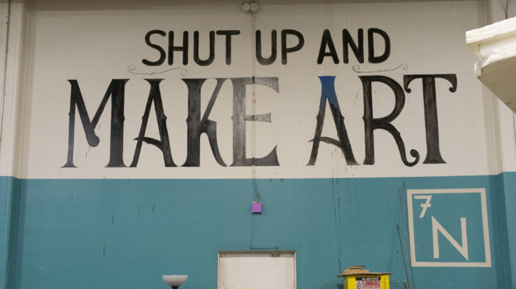 Wall art at The Generator that says "Shut up and make art"
