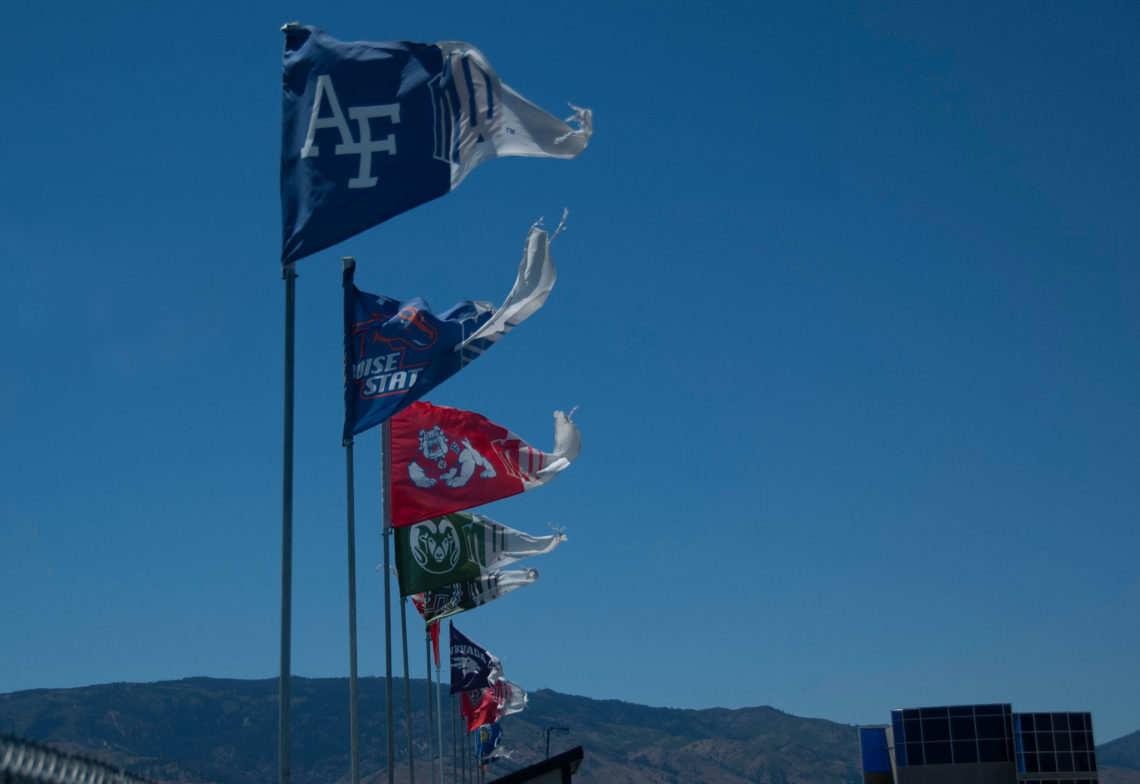 Flags representing the various Mountain West Conference universities fly above the stands at Mackay Stadium in Reno, Nev. The flags include the logos of Air Force, Boise State, Fresno State, Colorado State, Hawai'i, Nevada, New Mexico and San Jose State can be seen. The MW Mountain West Conference logo is seen right next to each of the school logos.