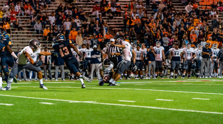 Freshman Brandon Talton kicks a field goal against UTEP on Sept. 21, 2019. Talton is wearing grey pants with a white jersey. His number, 43, is vaguely on his back.