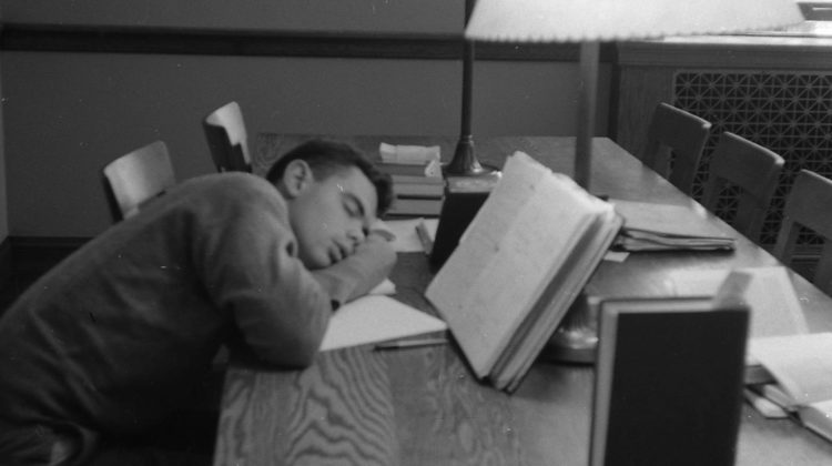 A man asleep studying.