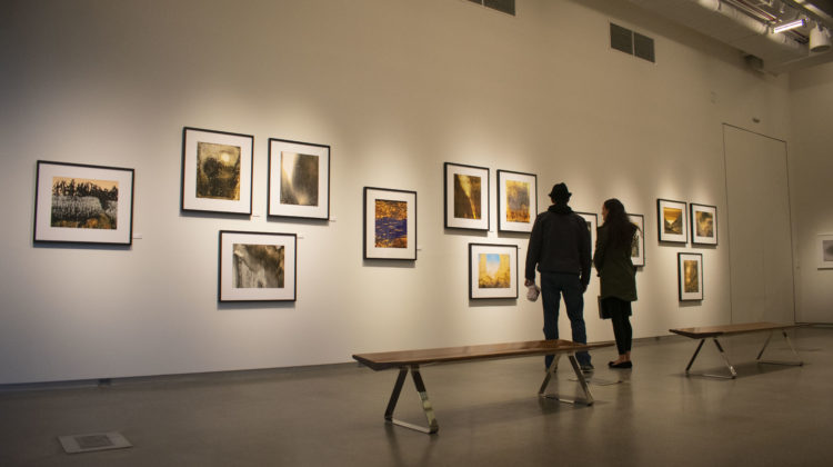 Two people are pictured looking at an art gallery at the University Arts Building.