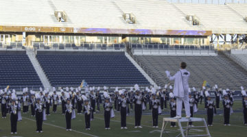 The Nevada marching band performs their show on Nov. 9. The band is wearing blue and silver uniforms.