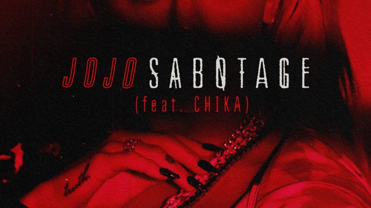 JoJo's single cover for "Sabotage (feat. CHIKA)." In red lighting, JoJo is looking to the left and the name of the single is written across her face.