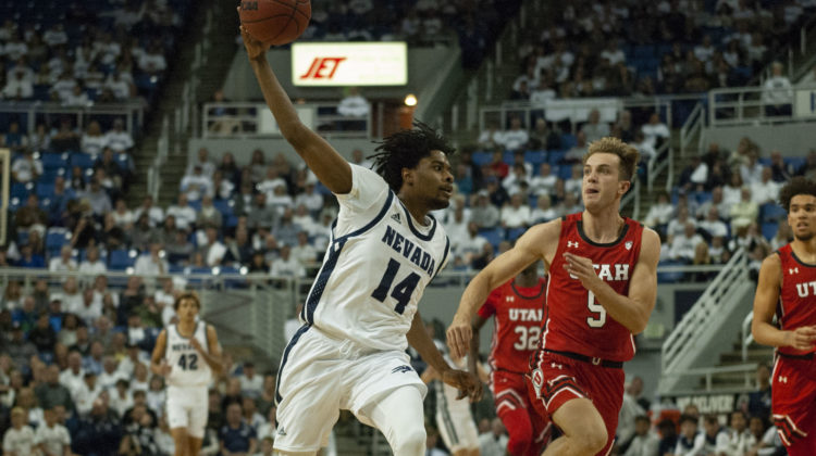 Lindsey Drew, wearing a white, pass the basketball during a game against Utah.