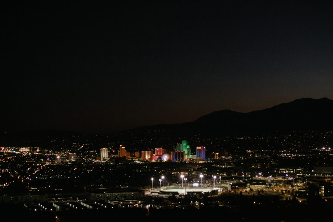 Night picture of the landscape of downtown Reno. There are lit up buildings.