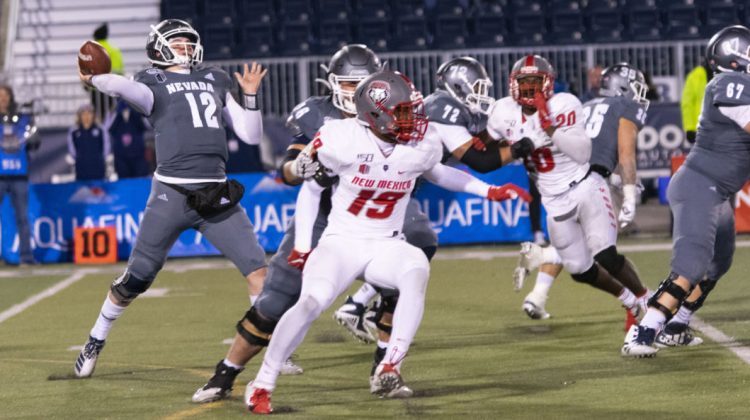 Quarterback Carson Strong drops back to pass during a game versus New Mexico on Nov. 2. Strong is wearing an all grey uniform with white lettering.