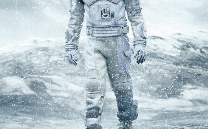 Movie poster with a man in an astronaut suit with ice behind him. The title "Interstellar" is written across the bottom.