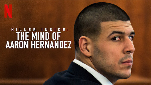 Aaron Hernandez looking over his shoulder in a suit. The title "Killer Inside: The Mind of Aaron Hernandez" is written on the left side of him.
