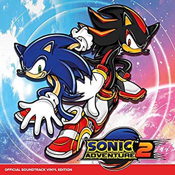 Sonic the Hedgehog (blue) and Shadow the Hedgehog (red and black) are pictured side by side. The title "Sonic Adventure 2" is written across the bottom.