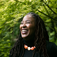 poet camille dungy standing in front of trees