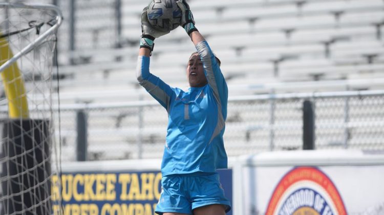 Nevada goalie jumps to catch the ball.