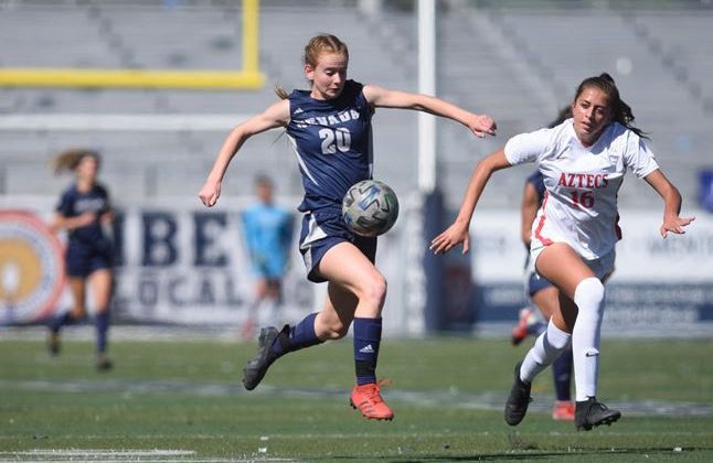 Emily Rich dribbles the ball down the field.