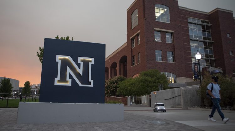 Large sign with the UNR logo next to a brick building