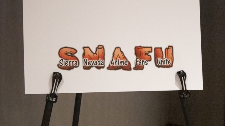The letters SNAFU and what they stand for "Sierra Nevada Anime Fans Unite" on a white poster.
