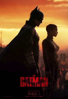 Batman stands next to Catwoman against the orange and yellow sunset, looking over the sitting of Gotham on a building. The name of the movie "The Batman" is in red letters below the two heroes in their completely black outfits.